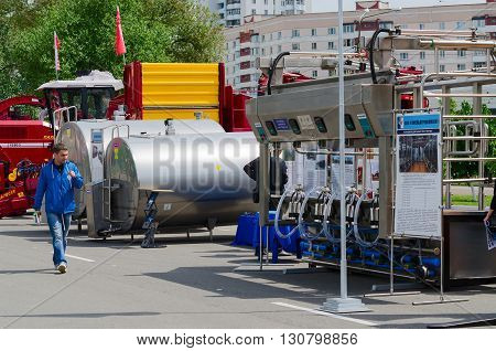 GOMEL BELARUS - MAY 19 2016: Unidentified man inspects equipment for food industry and agriculture in open air during XVII International Universal Exhibition-Fair 