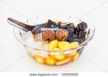 Traditional chinese dessert a delicious bean and herb in longan syrup with ice isolation on white