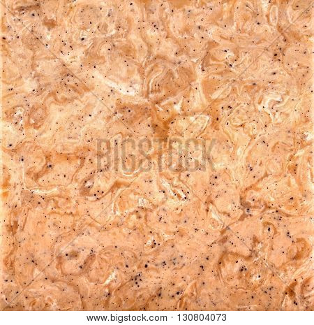 Pinkish-tan stone background with a swirled pattern square