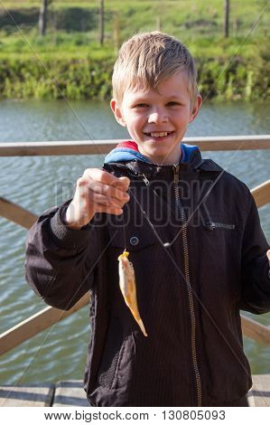 Young fisherman caught fish on fishing rod