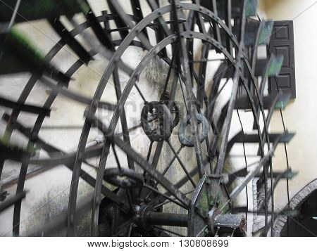 The rotary motion of the water wheel in an old historic watermill in italian village . Borghetto fraction of Valeggio sul Mincio (province of Verona) Italy