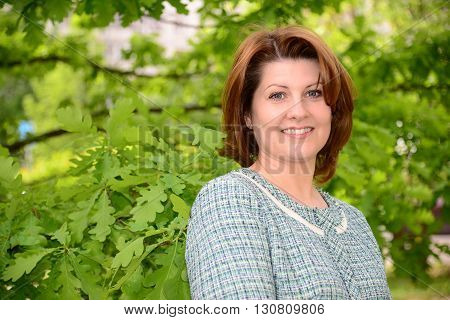 Portrait of a Russian woman near oak