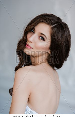 girl shows her beautiful hair. cheerful girl holding her beautiful hair curly