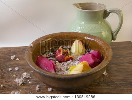 Jug And Old Bowl With Flowers Tulips And Chestnuts On A Wooden Table