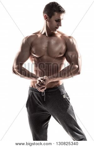 Strong bodybuilder man posing with perfect abs, houlders, biceps, triceps and chest. Isolated on white background