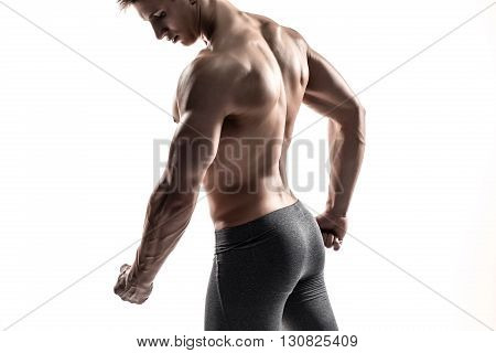 Close-up strong bodybuilder man posing with perfect abs, houlders, biceps, triceps and chest. Isolated on white background