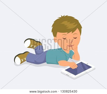 Baby lying down playing mobile games on the tablet. Learning, education and communication on the Internet using a mobile PC.