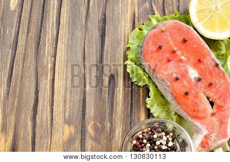 uncooked sockeye salmon steak and ingredients background with copy space