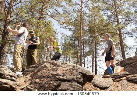 RUSSIA, ULAN-UDE - MAY 22, 2016: Russian Azimut - 2016. Orienteering competition is held annually in the Buryatia region. People at at control point at orienteering course.