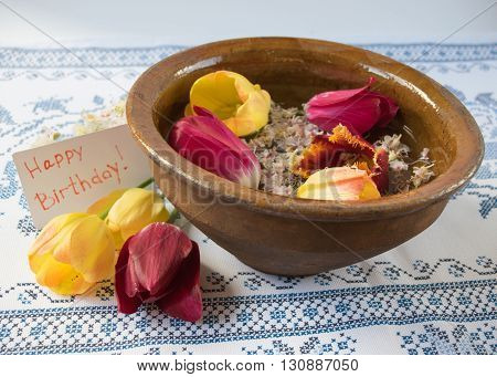 Old Bowl With Flowers Tulips And Chestnuts On A Beautiful Table