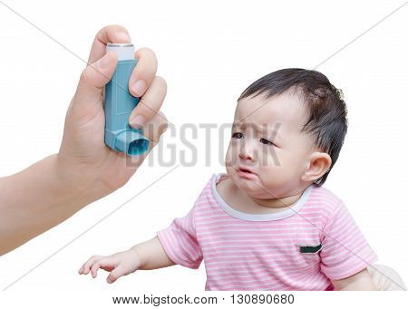 hand holding inhaler and little asian boy crying in background