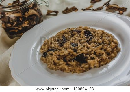 Traditional italian risotto with mushroom on white plate