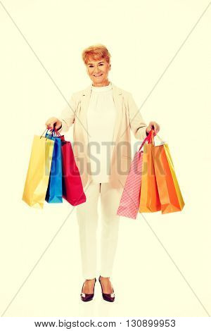 Happy business woman holging shopping bags