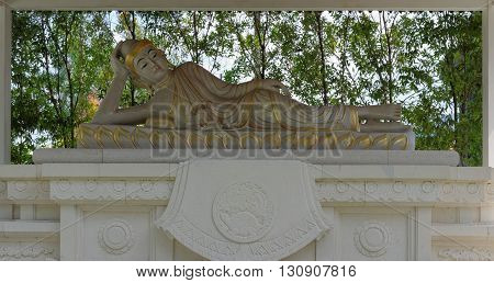 reclining buddha statue in mendut buddhist monastery