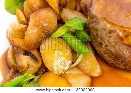 Delicious beef steak in demiglas sauce with vegetable garnish. Macro. Photo can be used as a whole background.