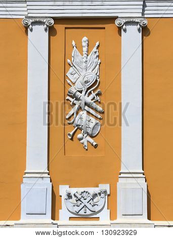 Classic pediment of the early nineteenth century with the coat of arms and decorative pilasters