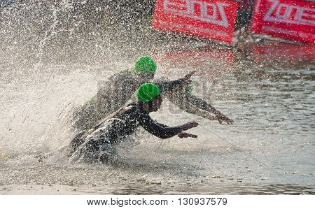 Grafham, Cambridgeshire, England - May 22, 2016:  Triathlon swimmers entering open water swim stage.