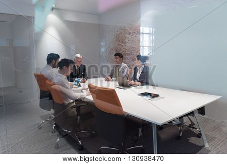 business people group brainstorming on meeting and businessman presenting ideas and projects oon laptop and tablet computer