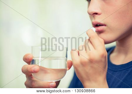 young boy are taking medicines and vitamins for help Sick and healthy