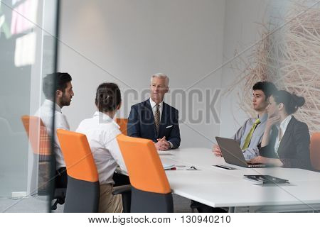 business people group brainstorming on meeting and businessman presenting ideas and projects oon laptop and tablet computer