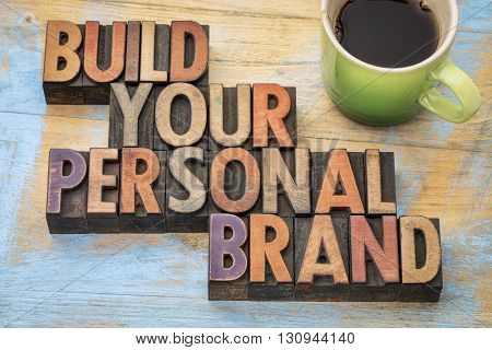 build your personal brand - motivational concept in vintage letterpress wood type block with a cup of coffee