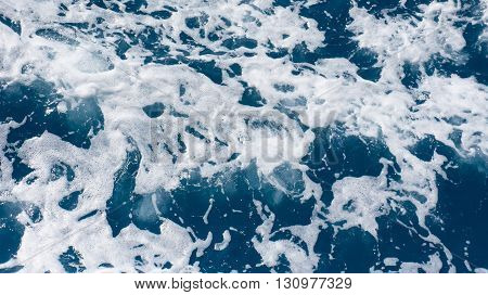 Restless foamy blue sea water with splash