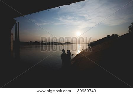 Romantic silhouettes of couple against the sunset sky