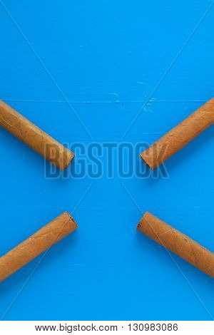 Detail of luxury Cuban cigars on the blue desk