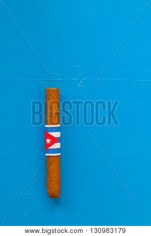 Detail of luxury Cuban cigars on the blue desk