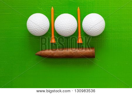 Luxury Cuban cigar and golf equipments on the wooden green table