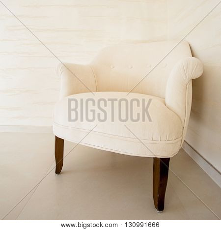 View of comfortable soft chair in bright interior