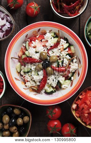 Shopska salad with cheese, tomato, cucumber, onion, olives and chili peppers