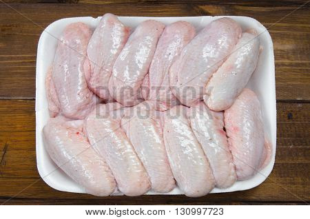 fresh raw chicken wings on wooden table