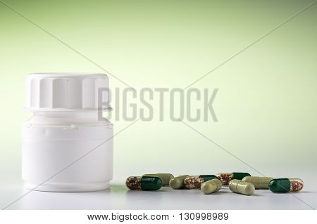 Medicine bottle and various colorful medical pills and drugs for pharmacological treatment