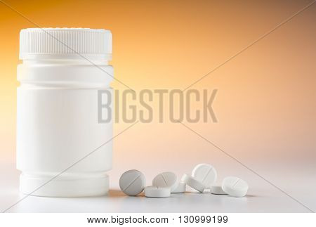 Medicine bottle and various round pills and drugs for pharmacological treatment