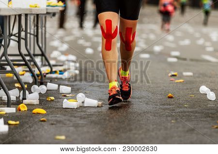 Legs Female Runner Red Kinesio Tape On Knees Run Next To Water Point