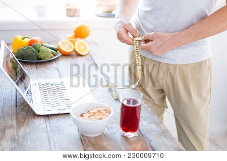 Daily Measurement. Close Up Of Male Attractive Hands Biohacking His Body While Eating Granola And Me