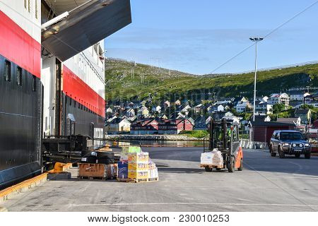 08-19-2017 Finnmark, Norway: Loading And Unloading Of Goods On Hurtigruten Packet Ship