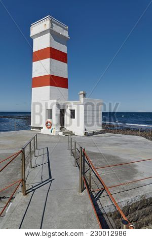 Small lighthouse on the tip of a peninsula