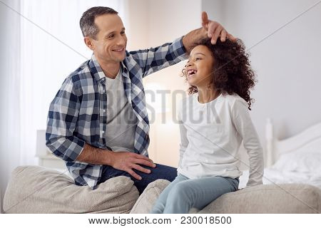 My Darling Child. Nice Content Loving Ark-haired Man Smiling And Talking With His Daughter And Cares