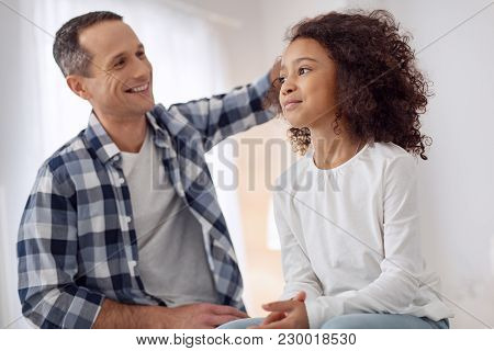 My Best Child. Nice Joyful Loving Dark-haired Man Smiling And Talking With His Daughter And Caressin