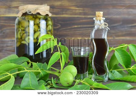Green Walnut Liqueur Nocino On Wooden Background