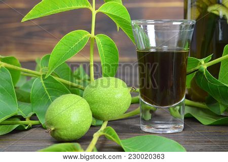 Green Walnut Liqueur Nocino On Wooden Background
