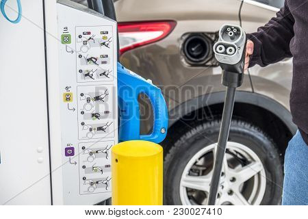 Limburg , Germany - February 11 2018 : Man Charging His Electric Car In The Winter