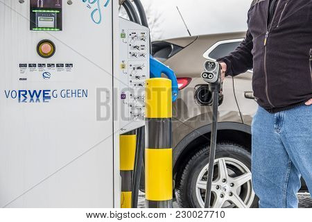 Limburg , Germany - February 11 2018 : Man Charging His Electric Car In The Winter