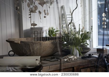 London, Uk - April 22, 2016: White Tulips In A White Vase On A Wooden Table. Rolls Of Paper, A Large