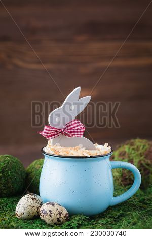 Wooden Polka Dot Grey Rabbit In A Blue Cup On The Grass Background, Easter Postcard Concept, Toned
