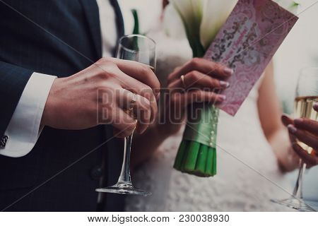 Bride Is Holding Glasses And Wedding Bouquet