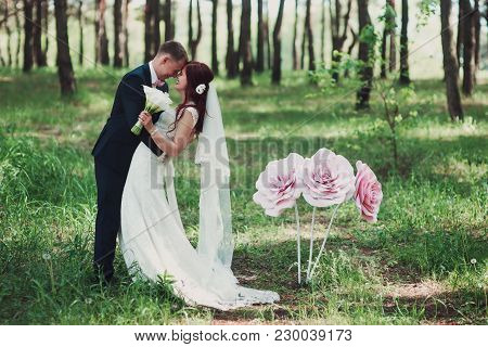 Bride And Groom Hugging At The Forest.