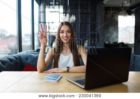 Young Woman Working On Her Laptop In The Restaurant.
